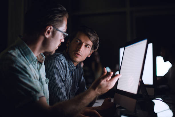 istock business team discussing current issues sitting at the Des 1005631034