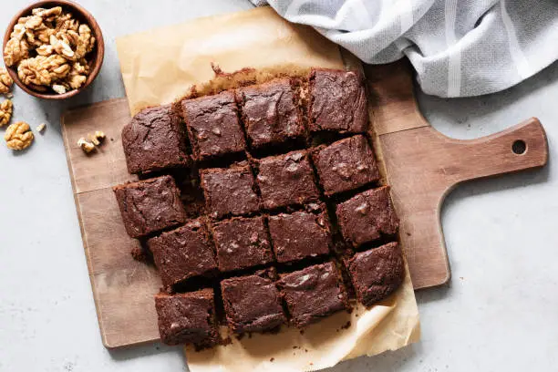 Photo of Chocolate brownie squares on cutting board, top view