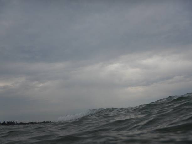 istock Rough sea and cloudy sky on the beach 1005636600