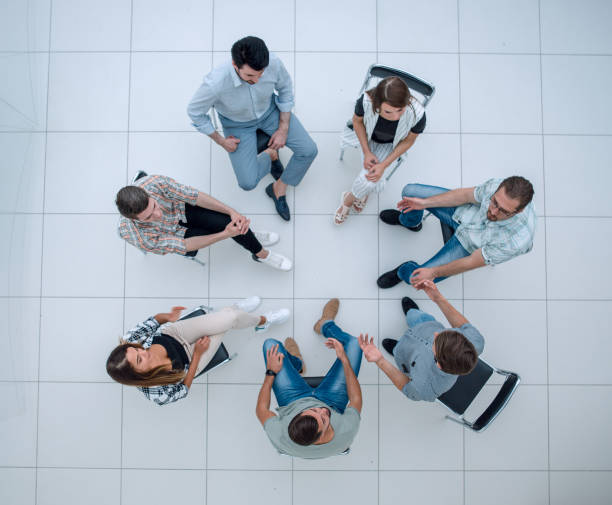 istock top view.boss and business team pointing at you 1005636934