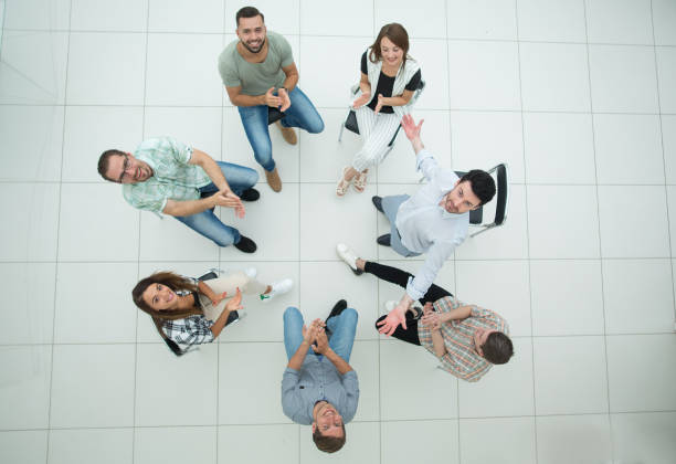 istock top view.smiling business team applauds 1005637110