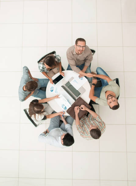 istock top view.an informal meeting with business partners 1005641328