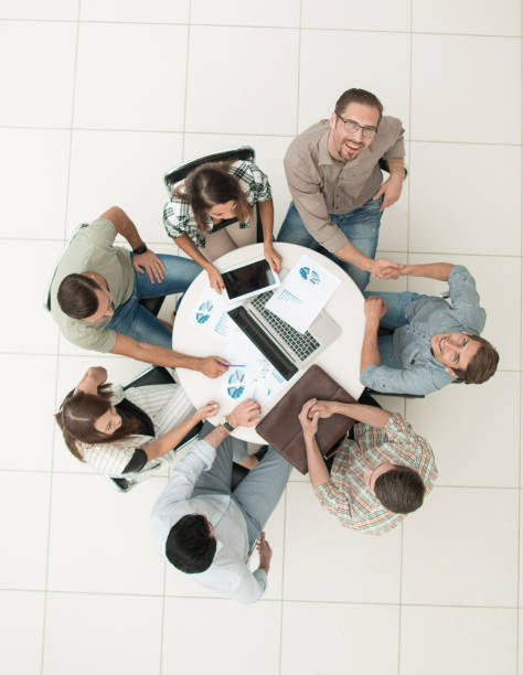 istock top view.staff welcoming each other at the working meeting 1005641380