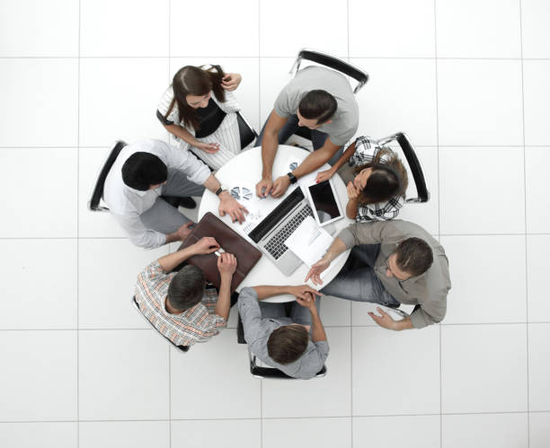 istock top view.the business team holds a round table 1005641388