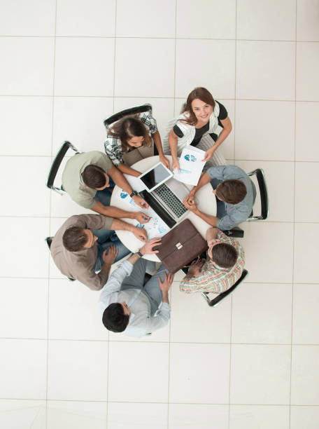istock top view.business team discussing new financial project 1005641404