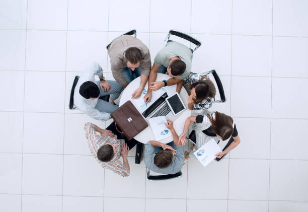 istock top view.employees make a financial report 1005641452