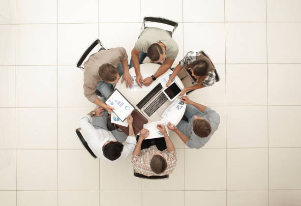 istock top view.the business team holds a round table 1005643976