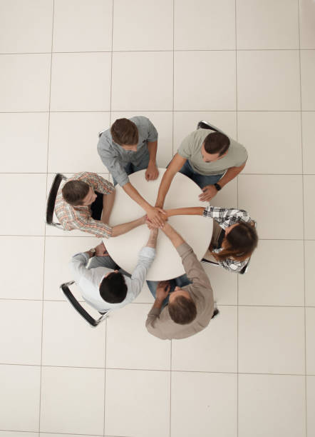 istock top view.business team putting their hands together 1005644174