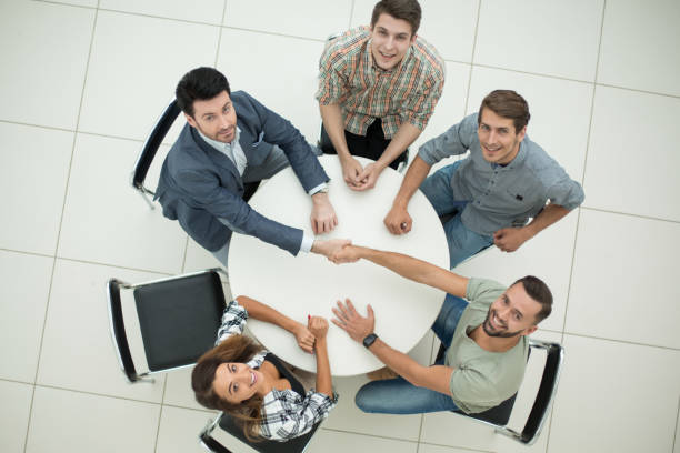 istock top view. HR Manager welcomes new employee 1005644352