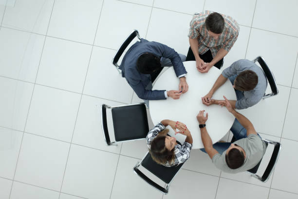 istock top view.Manager and creative team sitting at the round table 1005644374