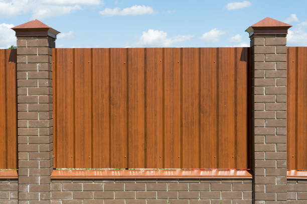 Metal fence private area with columns of brick.