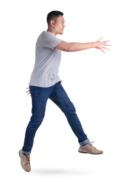 istock Levitation. Young Asian man jumping dancing walking 1005659420