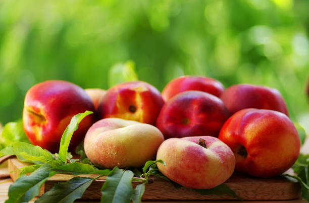 istock ripe peaches and leaves on table 1005678800