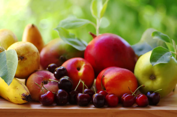 istock ripe cherries and assorted fruits on table 1005680862