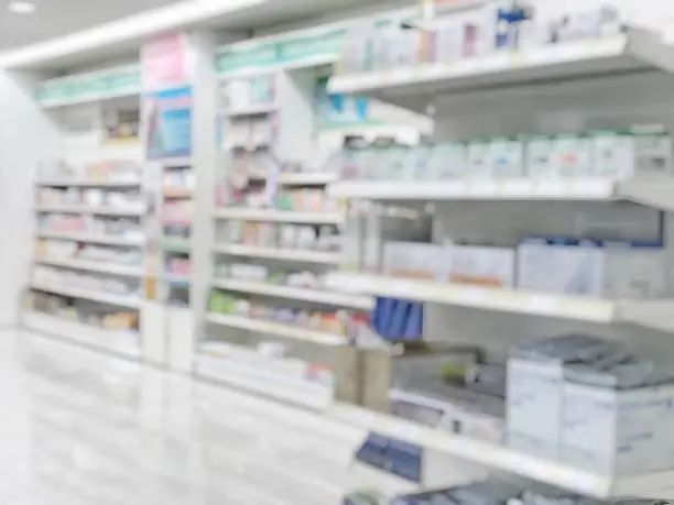 Pharmacy store or drugstore blur background with drug shelf and blurry pharmaceutical products, cosmetic and medication supplies on shelves inside retail shop interior