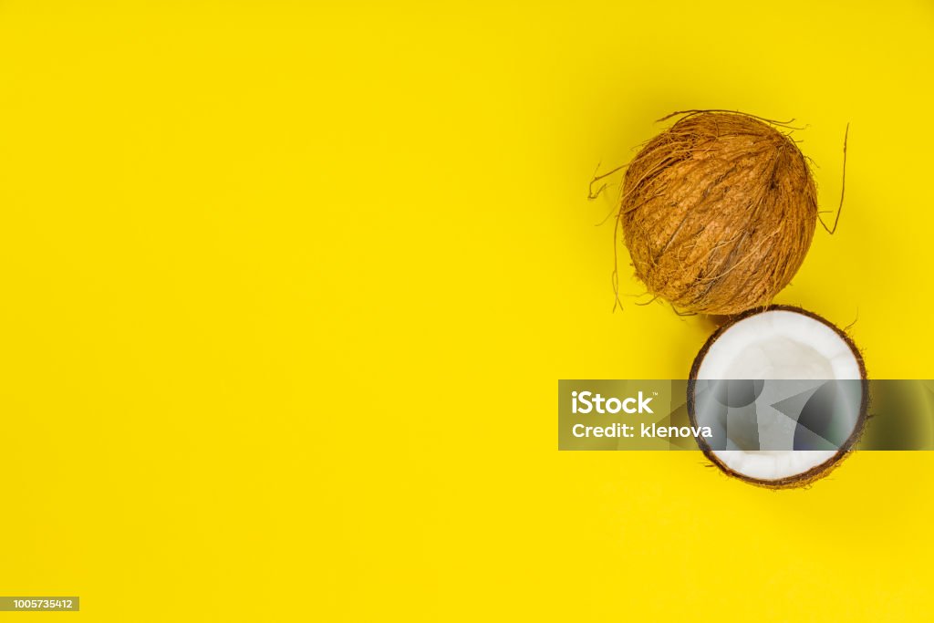 Coconuts on yellow background Coconuts on yellow background, flat lay, copy space Coconut Stock Photo