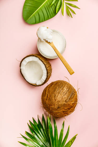 istock Coconut oil, tropical leaves and fresh coconuts 1005735444