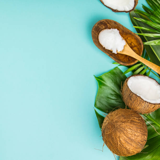istock Coconut oil, tropical leaves and fresh coconuts 1005735450