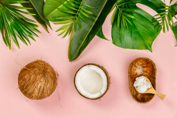 istock Coconut oil, tropical leaves and fresh coconuts 1005735454