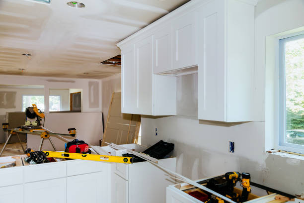 istock Custom kitchen cabinets in various stages of installation base for island in center 1005766046