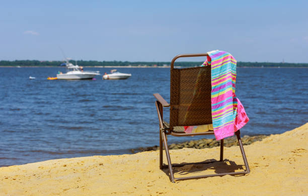 Beach chair on sand and summer hat beach overlooking the sea family vacation