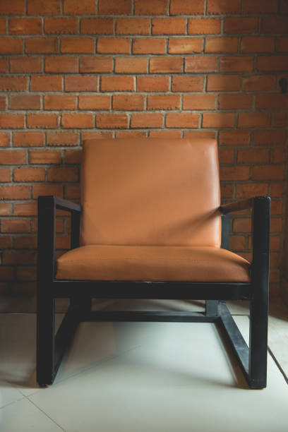 istock vintage chair standing beside the wall 1005768800
