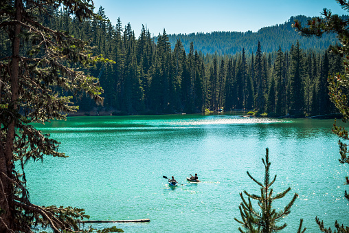 People kayaking on Elk lake in Central Oregon in the Cascade Mountains