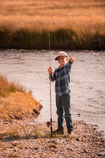 Boy Fishing In The Mountains