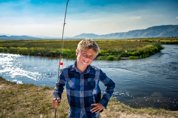 istock 7 Year Old Boy Fishing On A River 1005778972