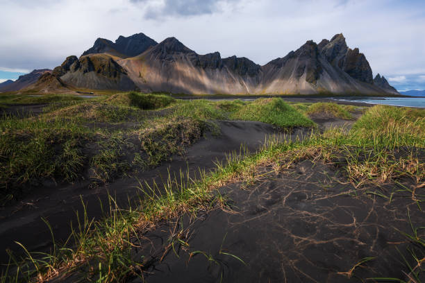 istock Black sand dunes with the Vestrahorn (Batman Mountain) 1005779268