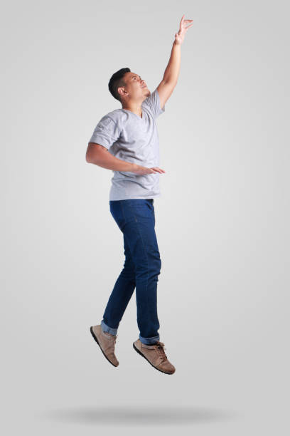 istock Levitation. Young Man Walking Jumping on Air 1005781628