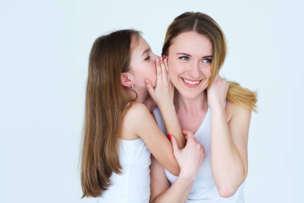 istock mom kid communication child sharing secret 1005791090
