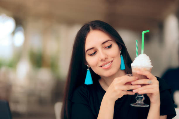 Girl Holding Coffee Drink with Whipped Cream on Top
