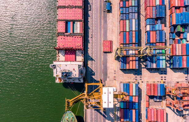 istock Aerial view of cargo ship loading container and cargo plane. Logistics and transportation of International. Business import export and logistic concept. 1005812412