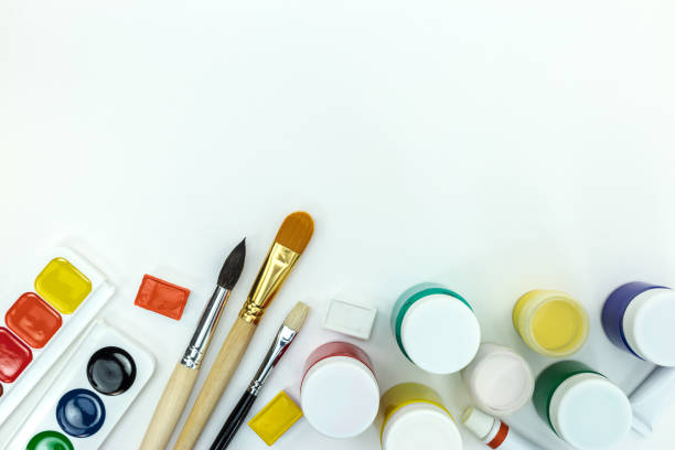 istock bright colored paints and set of brushes on white background 1005814920