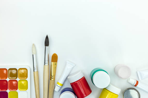 istock set of brushes and colorful paints on white desk 1005818812