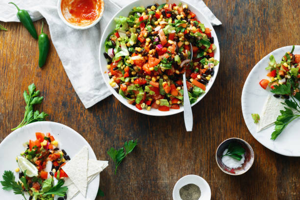 istock Taco salad on wooden table top view 1005824206