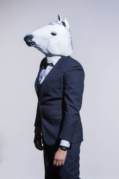 istock man with a horse mask on a light background 1005827692