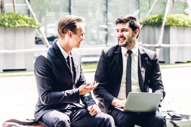 istock Image two business partners in black elegant suit talking and working together while discussing new strategy with laptop computer at city.Business and startup idea concept 1005831872