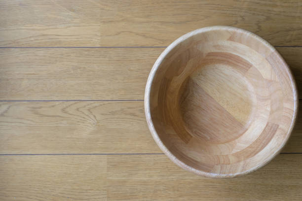 istock wood bowl on wooden table background 1005833668