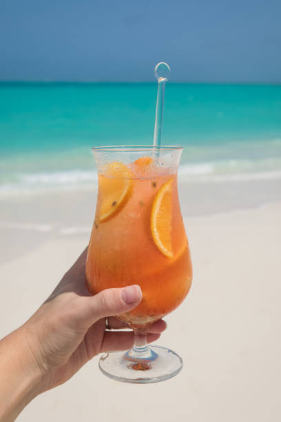istock Hand holding tropical cocktail in Maldives 1005836142