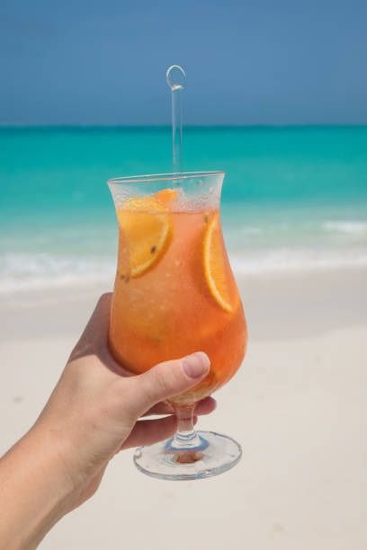 istock Hand holding tropical cocktail in Maldives 1005836150