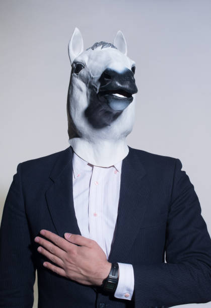 istock man with a horse mask on a light background 1005836306