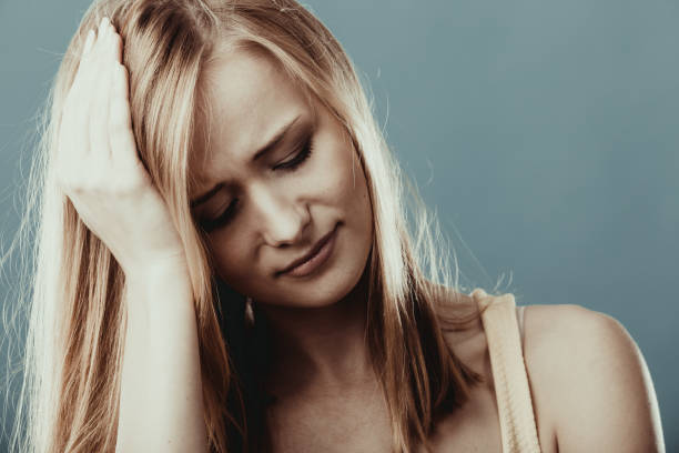 istock Headache. Woman suffering from head pain 1005839528