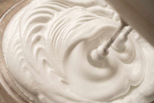 beaten egg white with the blender - whipped cream imagens e fotografias de stock