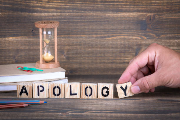 istock Apology. Wooden letters on the office desk 1005840742
