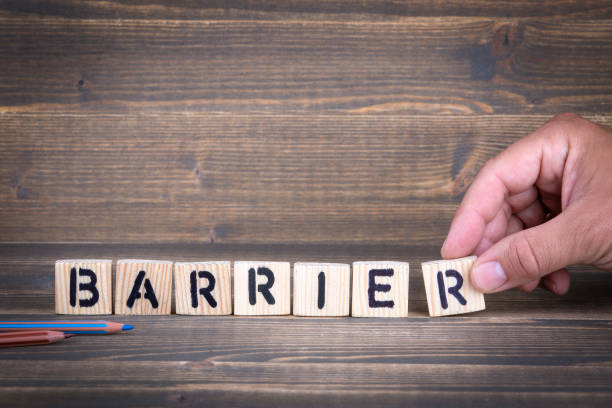 istock Barrier. Wooden letters on the office desk 1005842834