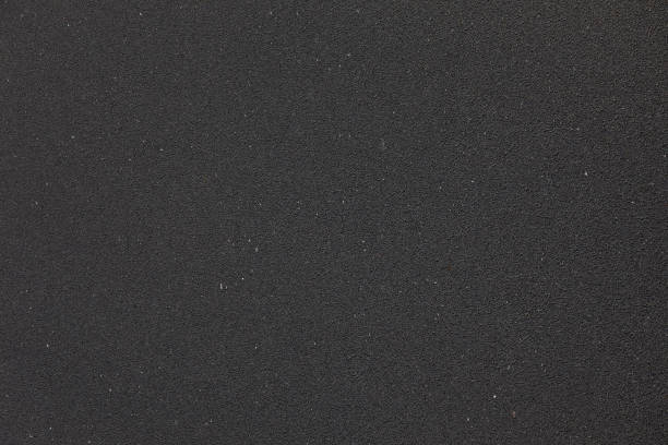 istock Asphalt road as background.Closeup view. 1005843564