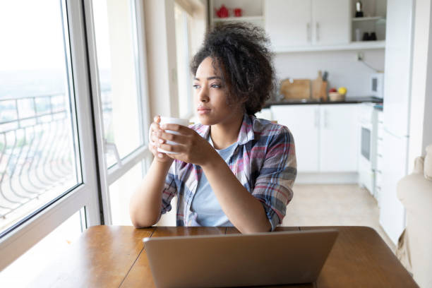 istock African woman drinking coffee at home 1005846568