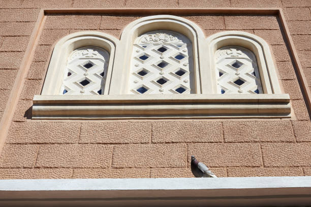 istock Pigeon standing on orthodox church window. 1005850236